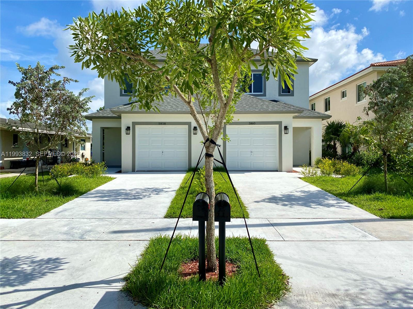 5860 Lincoln Street, Unit 5860 Hollywood, FL 33021 - Photo 1 of 21 a house view with a garden and pathway