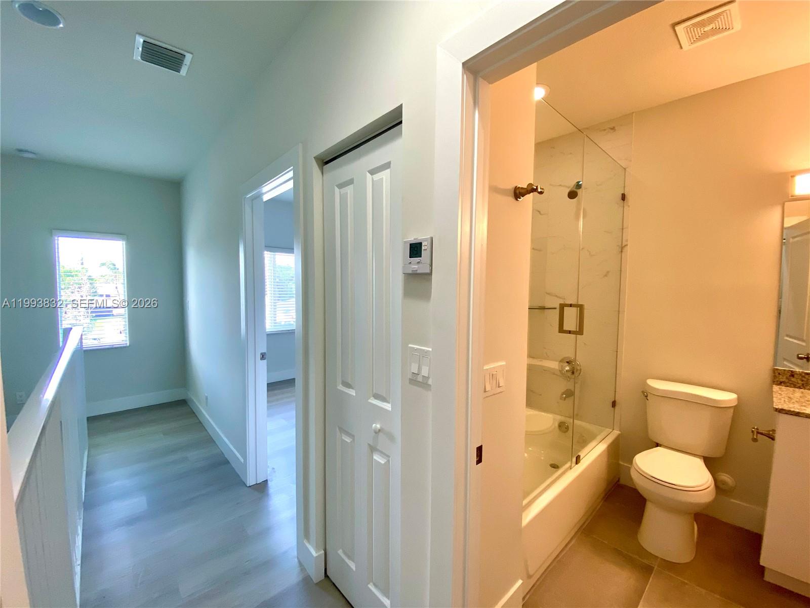 5860 Lincoln Street, Unit 5860 Hollywood, FL 33021 - Photo 12 of 21 a bathroom with a granite countertop toilet sink and shower