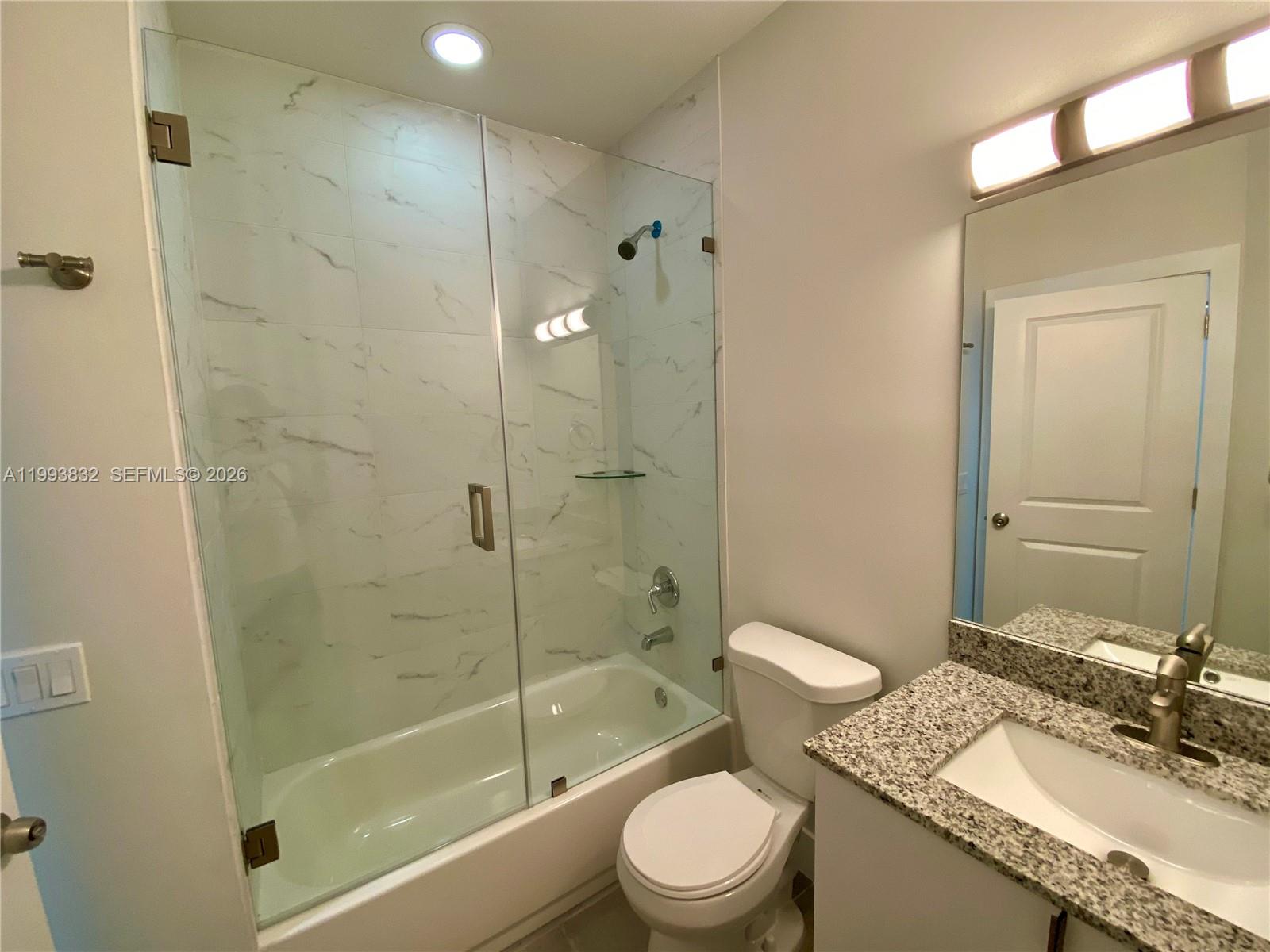 5860 Lincoln Street, Unit 5860 Hollywood, FL 33021 - Photo 13 of 21 a bathroom with a granite countertop sink toilet and shower