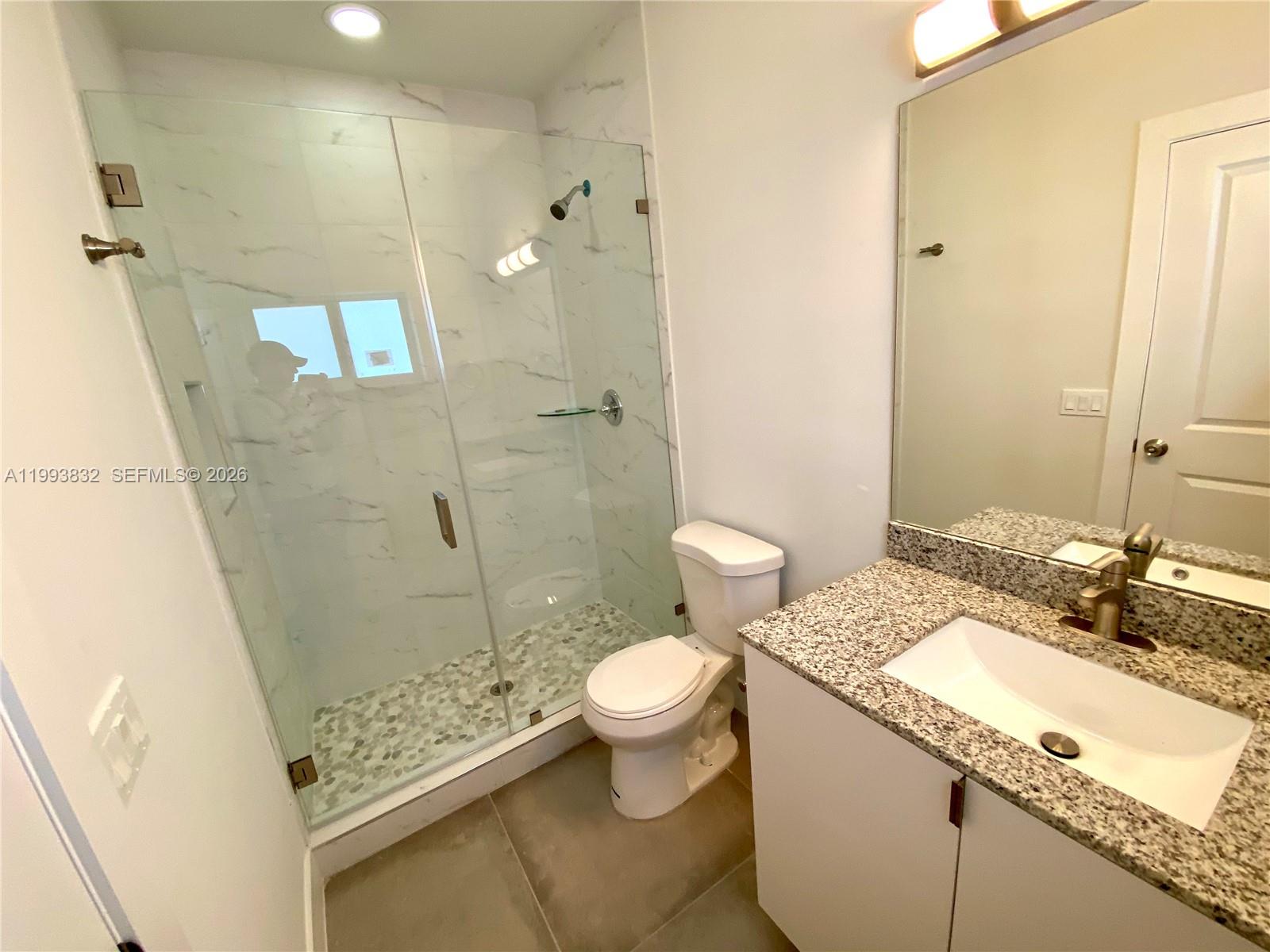 5860 Lincoln Street, Unit 5860 Hollywood, FL 33021 - Photo 19 of 21 a bathroom with a granite countertop sink toilet and shower
