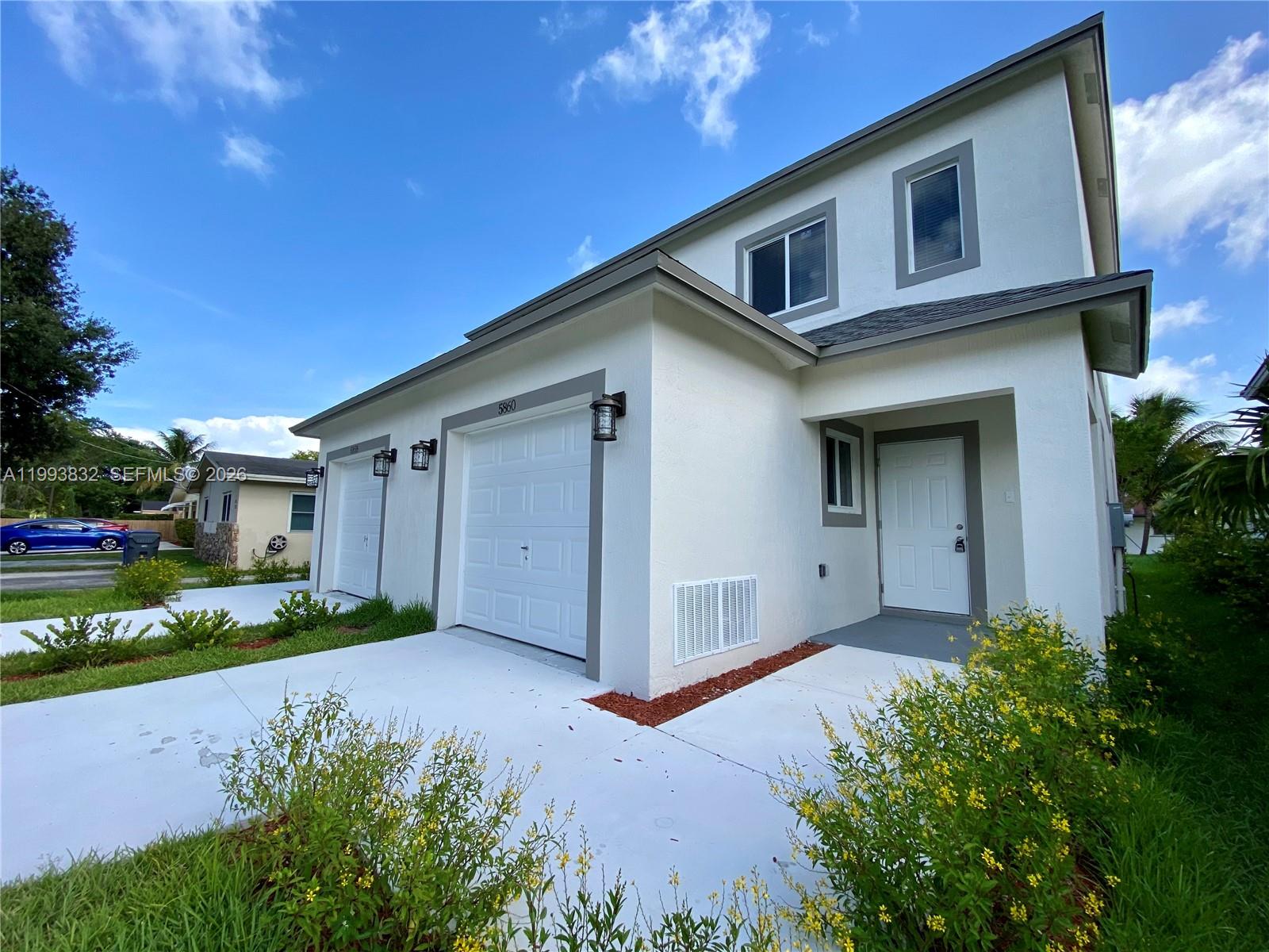 5860 Lincoln Street, Unit 5860 Hollywood, FL 33021 - Photo 6 of 21 a front view of a house with a yard
