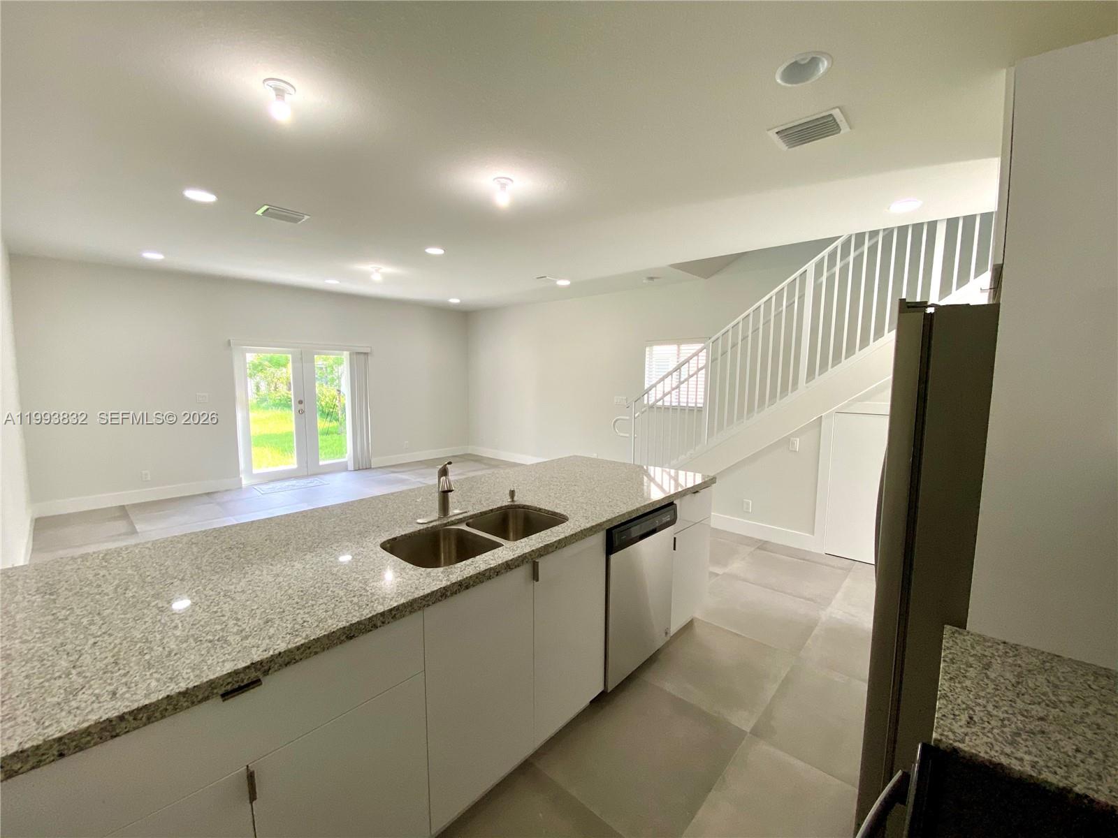 5860 Lincoln Street, Unit 5860 Hollywood, FL 33021 - Photo 8 of 21 a kitchen with kitchen island a sink and a refrigerator