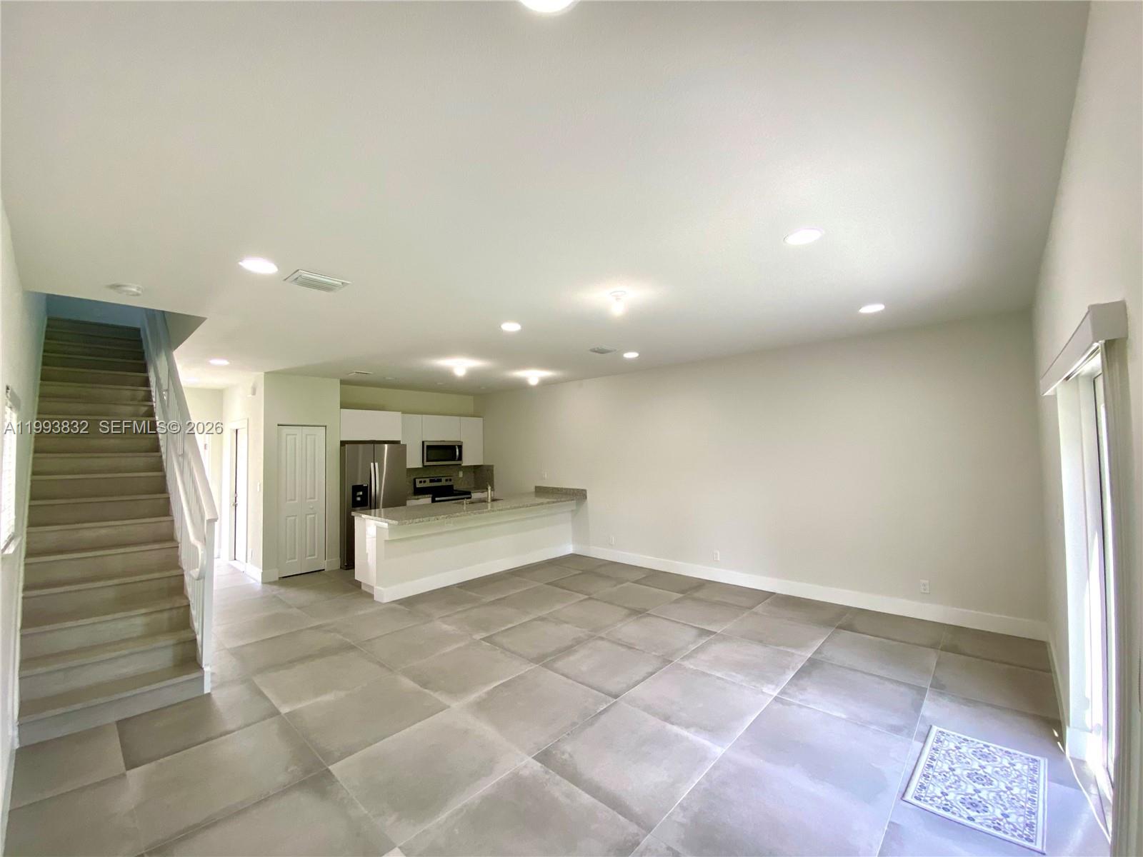 5860 Lincoln Street, Unit 5860 Hollywood, FL 33021 - Photo 9 of 21 a view of a hallway with stairs and a window