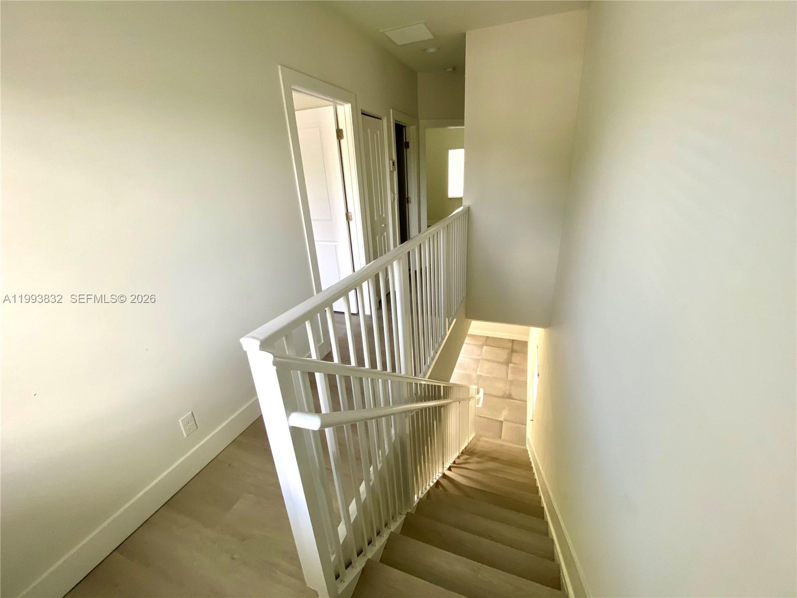 5860 Lincoln Street, Unit 5860 Hollywood, FL 33021 - Photo 10 of 21 a view of staircase with railing and white walls
