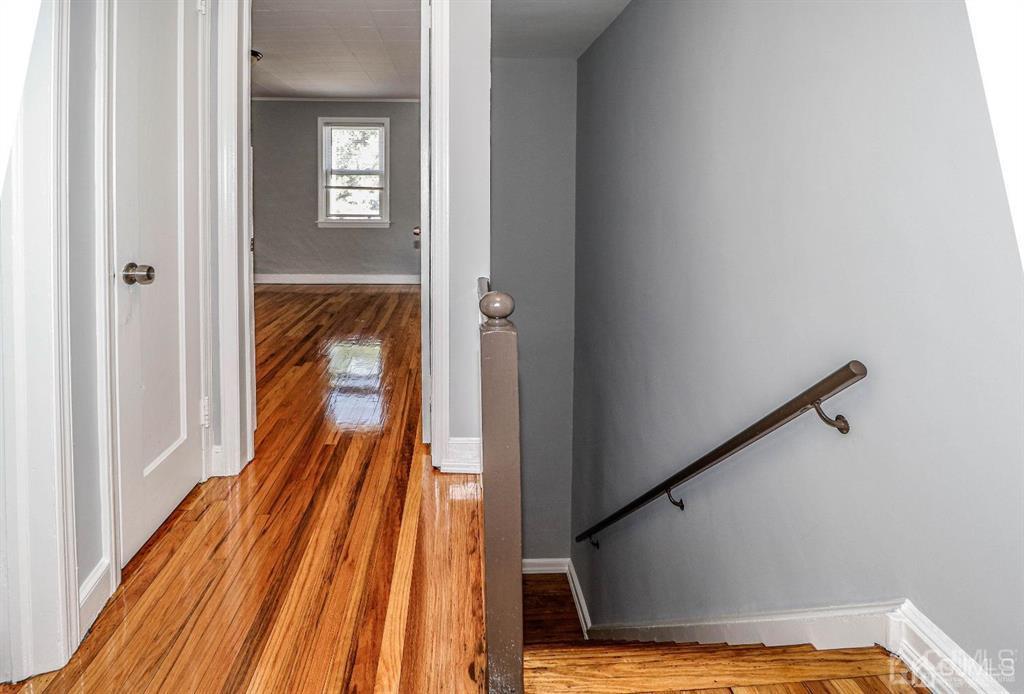 9 MacArthur Drive Edison, NJ 08837 - Photo 5 of 12 a view of a hallway with wooden floor and a bathroom