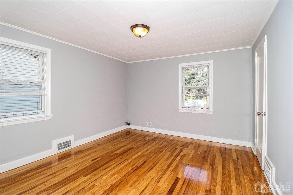 9 MacArthur Drive Edison, NJ 08837 - Photo 6 of 12 a view of a room with wooden floor and window
