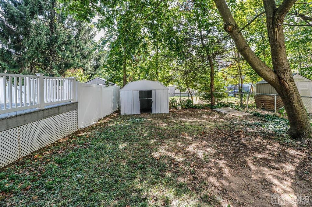 9 MacArthur Drive Edison, NJ 08837 - Photo 10 of 12 a view of a house with a small yard and a large tree