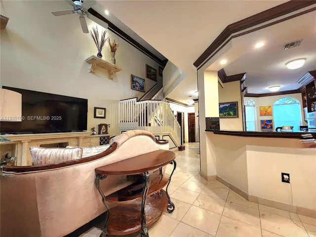 a dining hall with stainless steel appliances granite countertop a sink a refrigerator and a microwave