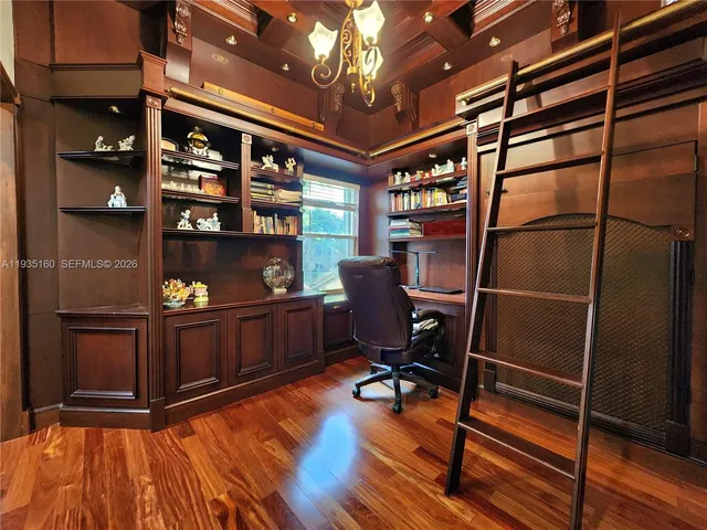 a bedroom with a bed dresser and a large window