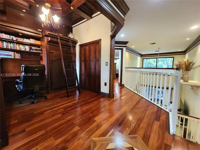 a large bedroom with a bed and a chandelier