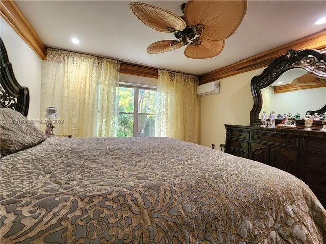 a bedroom with bed and wooden floor