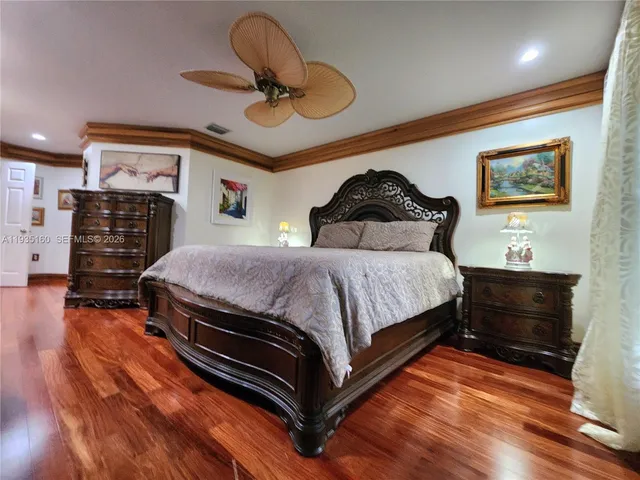 a bathroom with a granite countertop sink mirror bathtub and next to a window
