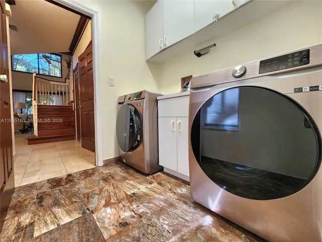 a view of a livingroom with workspace and a ceiling fan
