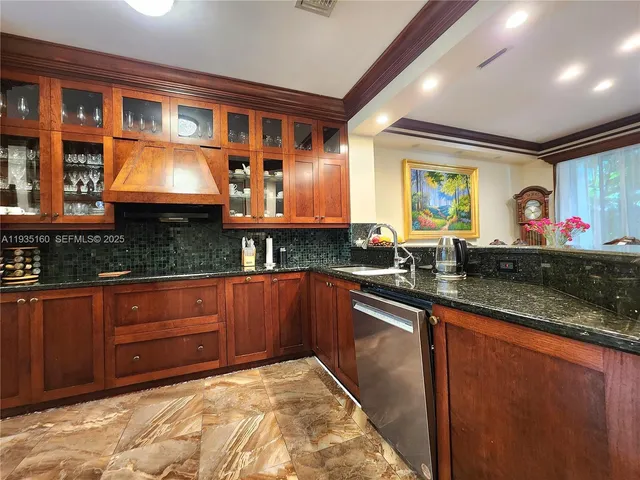 a kitchen with granite countertop a stove and cabinets