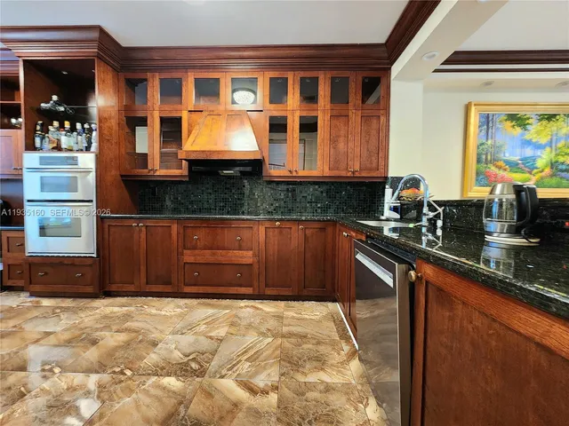 a kitchen with stainless steel appliances granite countertop a stove and a refrigerator