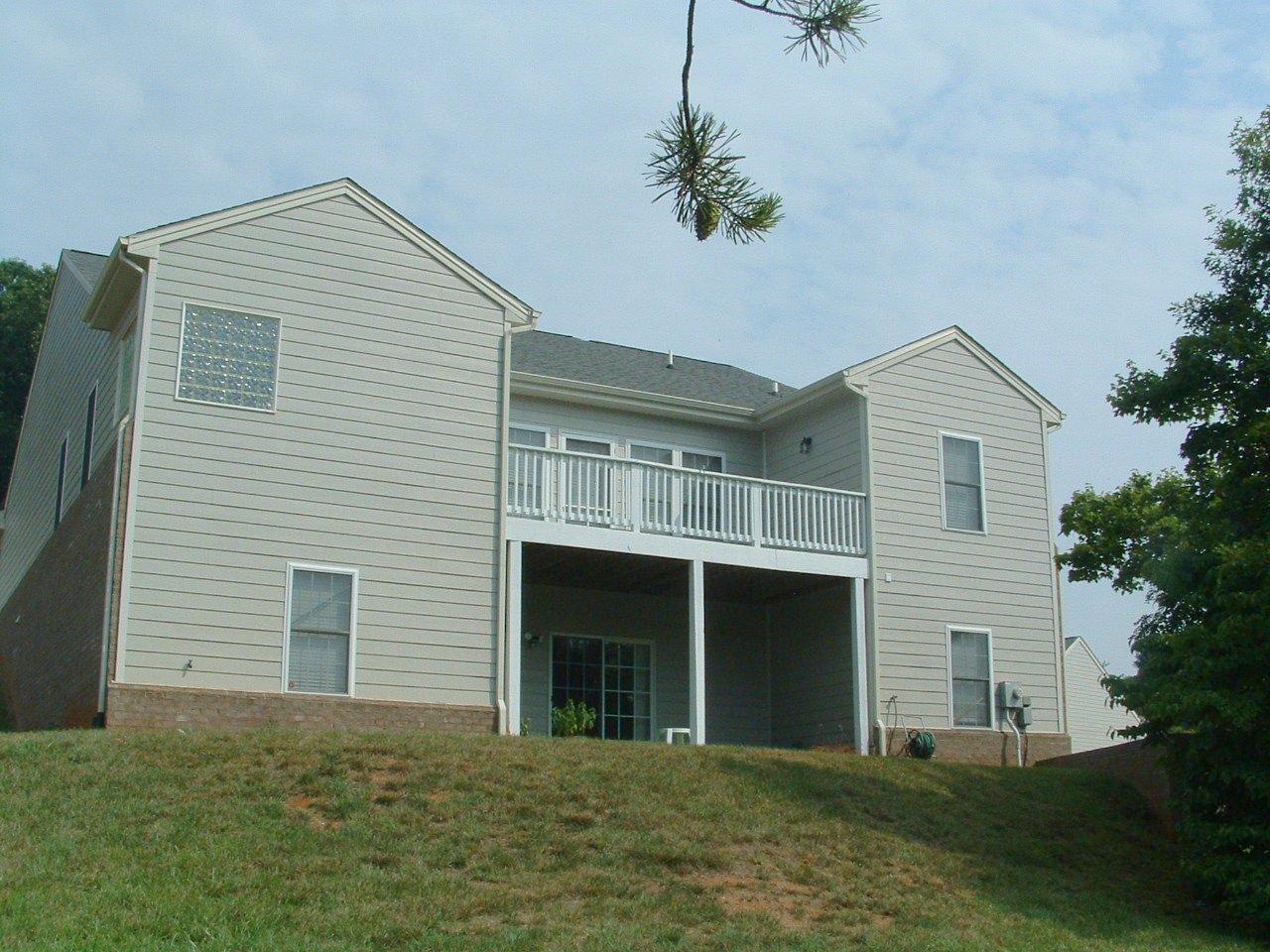 5428 Quail Ridge Circle Roanoke, VA 24018 - Photo 2 of 4 a front view of a house with a garden and yard