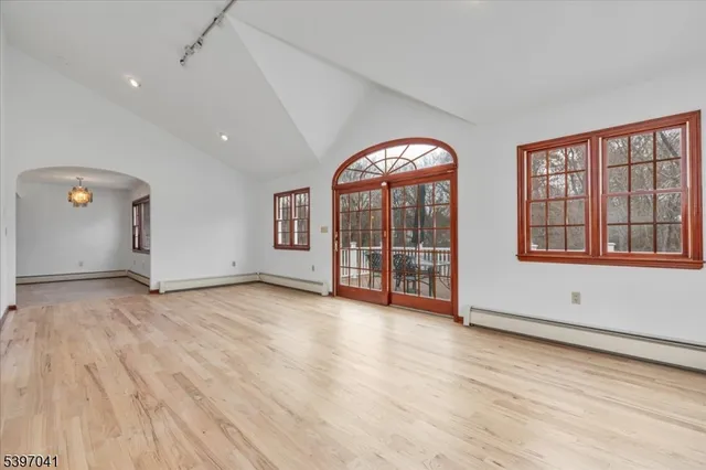 a view of an empty room with wooden floor