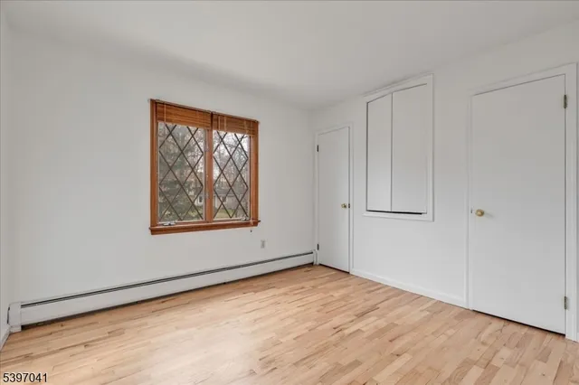 a view of an empty room with chandelier