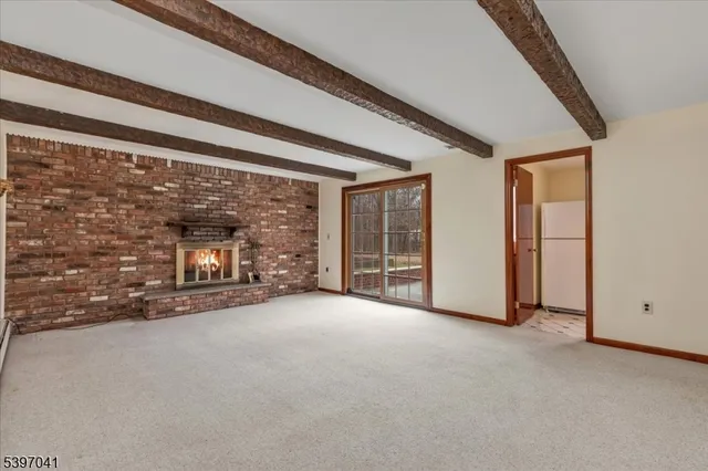 a view of an empty room with a fireplace