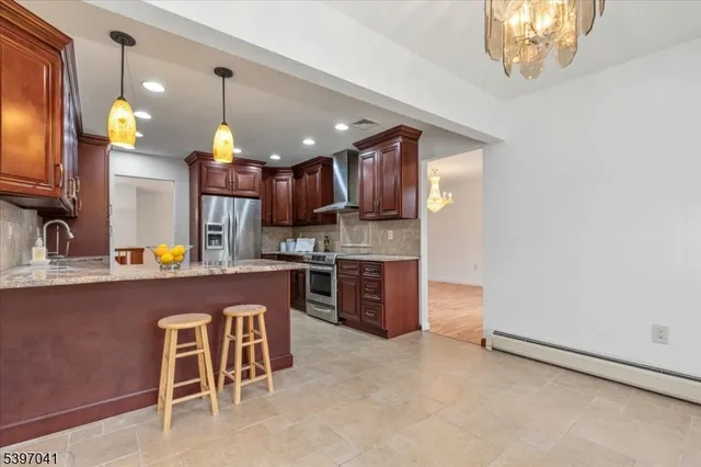 a kitchen with a sink a counter top stainless steel appliances and cabinets