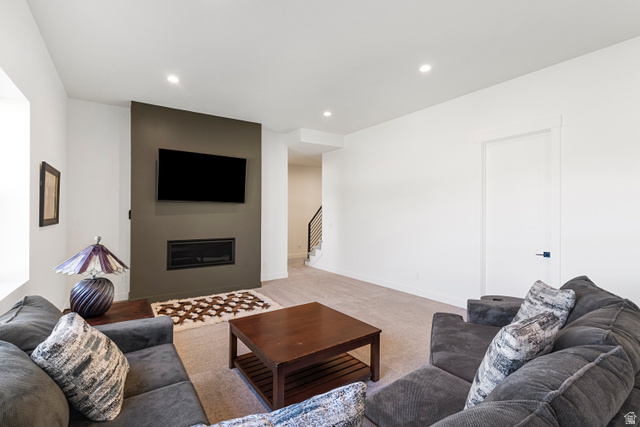 851 Grandview Drive Morgan, UT 84050 - Photo 37 of 68 Living area featuring a modern linear fireplace with a dark accent wall, recessed lighting, and light-toned carpeting
