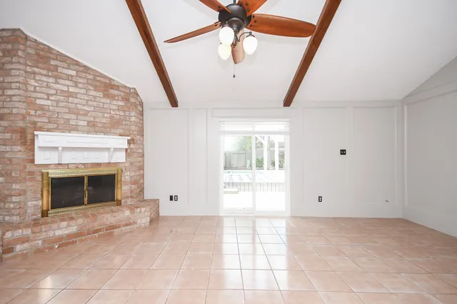 a view of an empty room with a fireplace