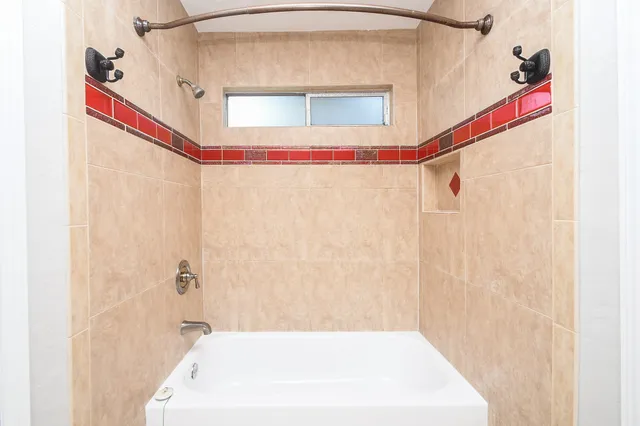 a bathroom with a bathtub and a shower