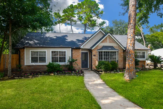 a front view of a house with a yard and porch