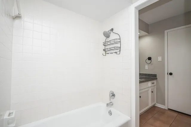 a bathroom with a bathtub and a sink