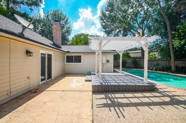 a view of backyard of house and outdoor seating