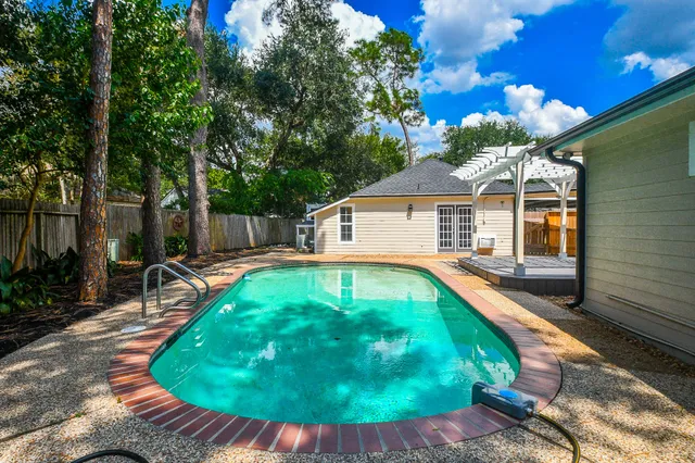 a swimming pool with outdoor seating yard and patio