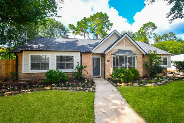 a front view of a house with a yard and porch