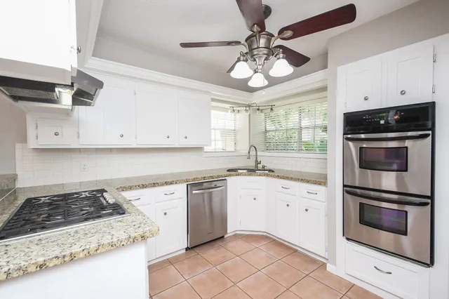 a kitchen with stainless steel appliances granite countertop a stove and a sink