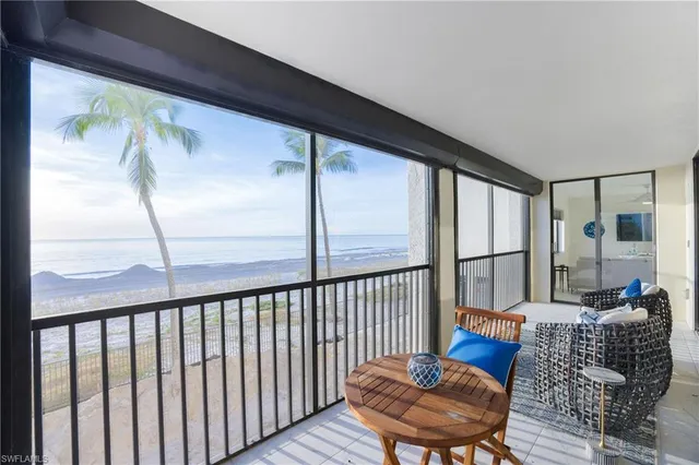 a balcony with table and chairs
