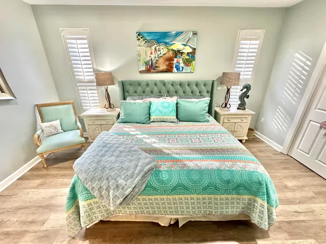 a bedroom with a bed and a painting on the wall