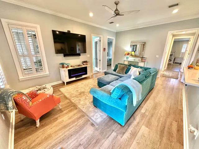 a living room with furniture and a wooden floor
