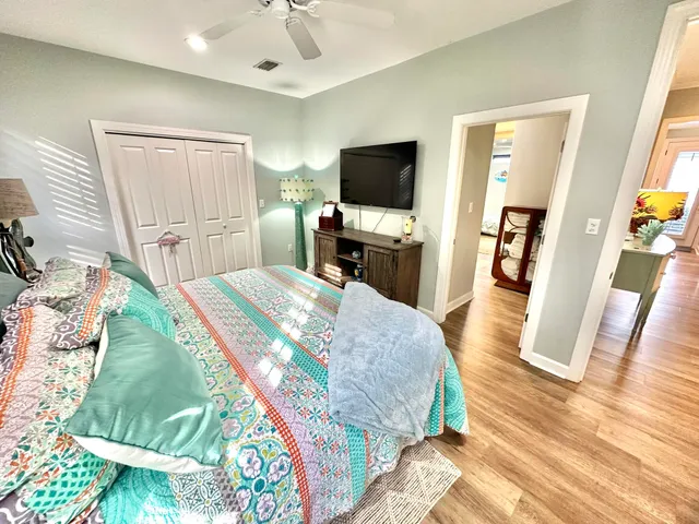 a bathroom with a sink a toilet a mirror and shower