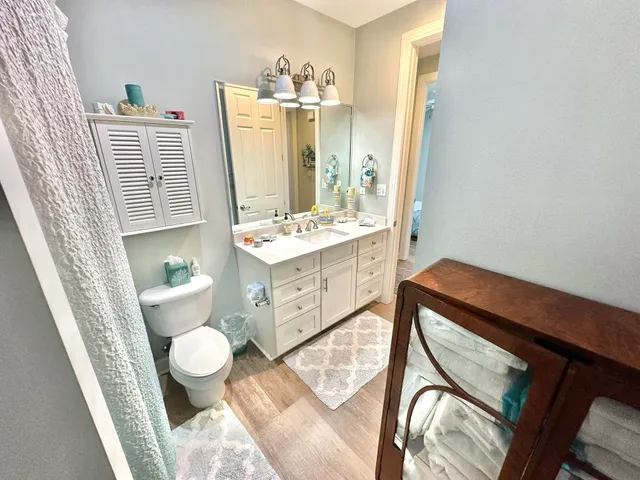 a bedroom with a bed and painting on the wall