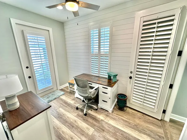 a bedroom with a bed windows and a rug