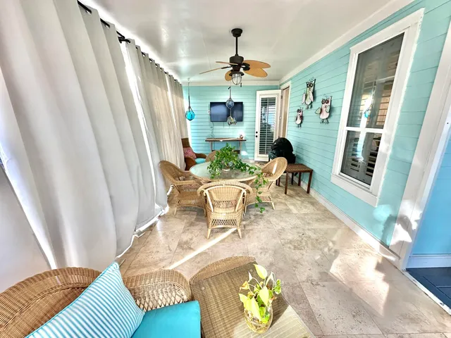 a front view of a house with a yard and potted plants