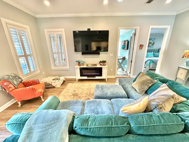 a view of a dining room with furniture a rug and wooden floor