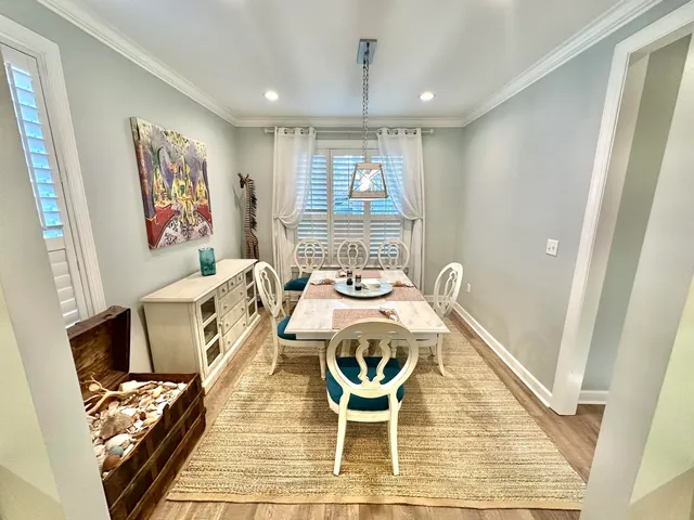 a view of a dining room with furniture and a window