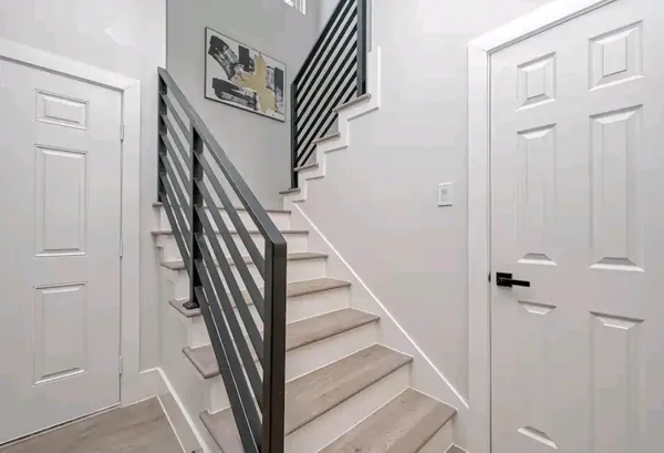 a large bed sitting in a bedroom next to a window