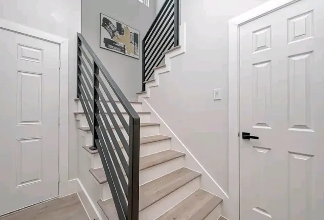 a large bed sitting in a bedroom next to a window