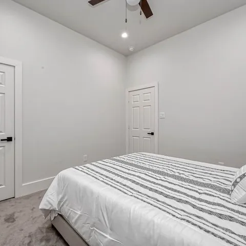 a large white bed in a white room