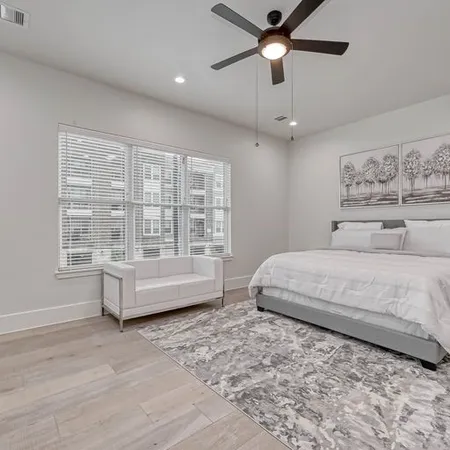 a spacious bedroom with a large bed and a window