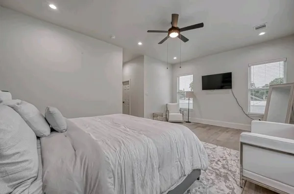 a bedroom with a large bed and a window