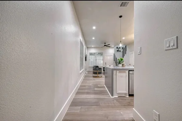 a kitchen with stainless steel appliances granite countertop a sink a stove and a wooden floors