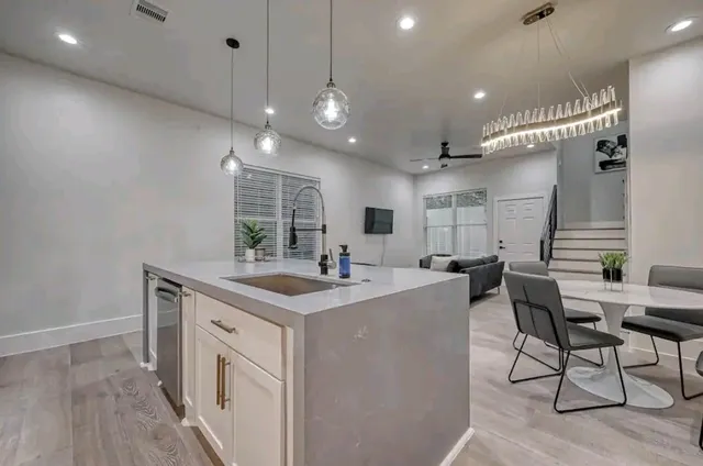 a kitchen with stainless steel appliances granite countertop a stove a sink and a refrigerator