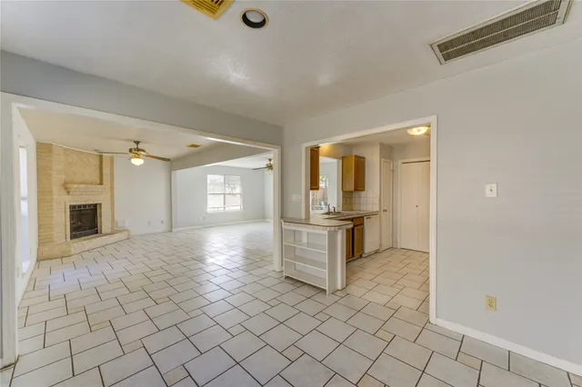 a view of a hallway with dining area and chandelier